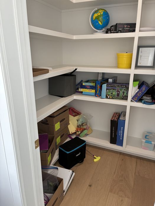 Kids' playroom — toy and craft storage (before)